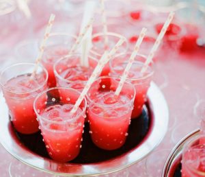 Red soft drinks in glasses with polka dot straws