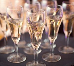 Three champagne flutes filled with champage