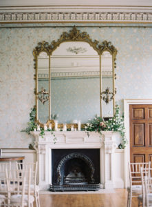 Fireplace at Pynes House wedding venue with a classical mirror sitting above it