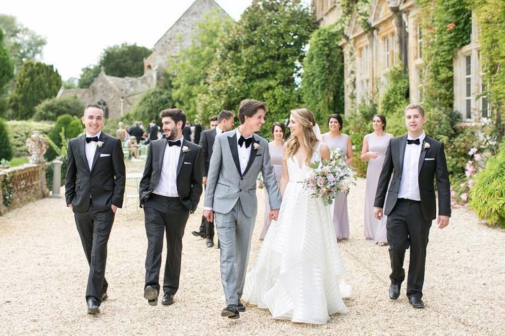 Wedding party walking outside a French chateau