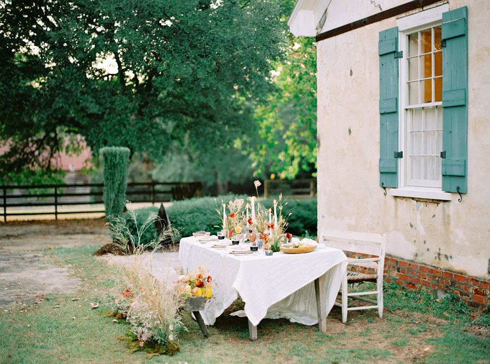 Outdoor wedding table with flowers and candles by Willow and Oak Events
