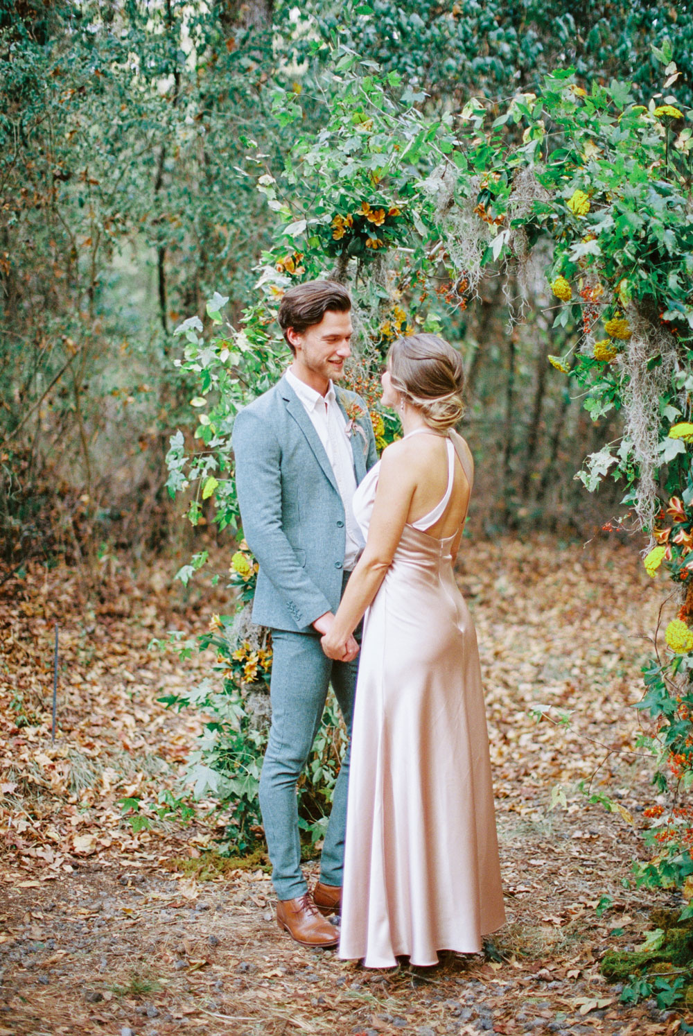 Married couple looking into each others eye in the woods