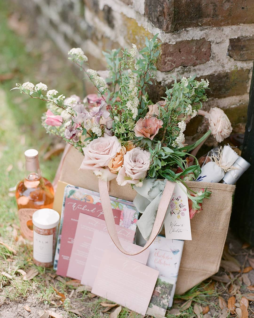 jute tote wedding welcome bag with paper goods and other gifts