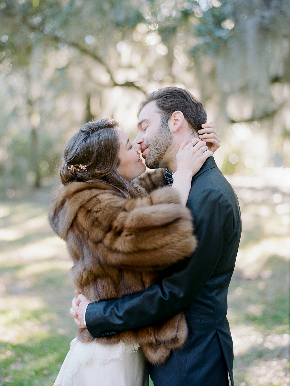 bride and groom almost kiss shot with a vintage fur coat heirloom