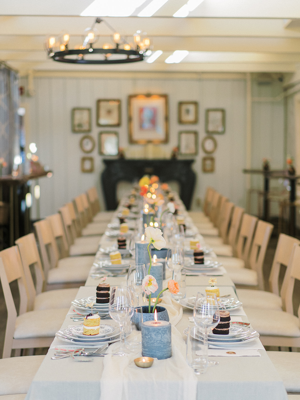 family style wedding table with sage green linen, textured pillar candles, Icelandic poppy ikebana centerpieces and mini naked cakes at each place setting for an intimate Charleston wedding planned by Willow and Oak and captured by Kylee Yee