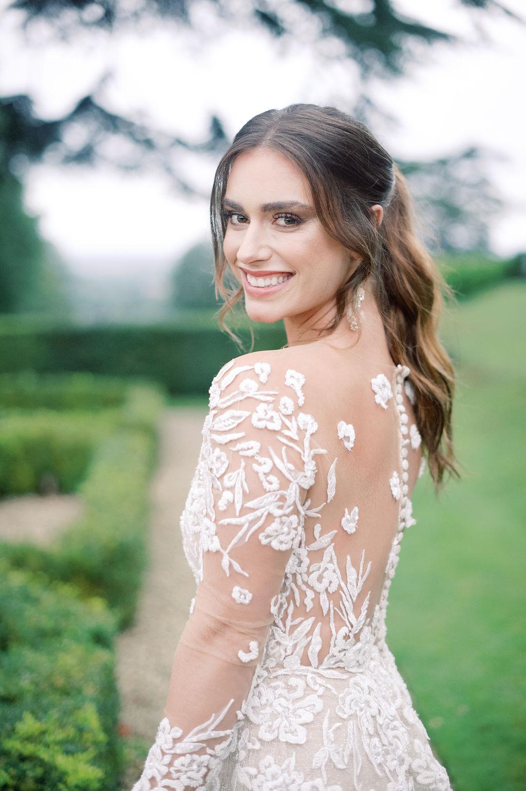 Lee Petra Grebenau wedding dress with illusion back and lace applique flowers, plus a sexy bridal ponytail; photography by Julie Livingston at an English country estate Hedsor House with planning and design by Willow and Oak Events