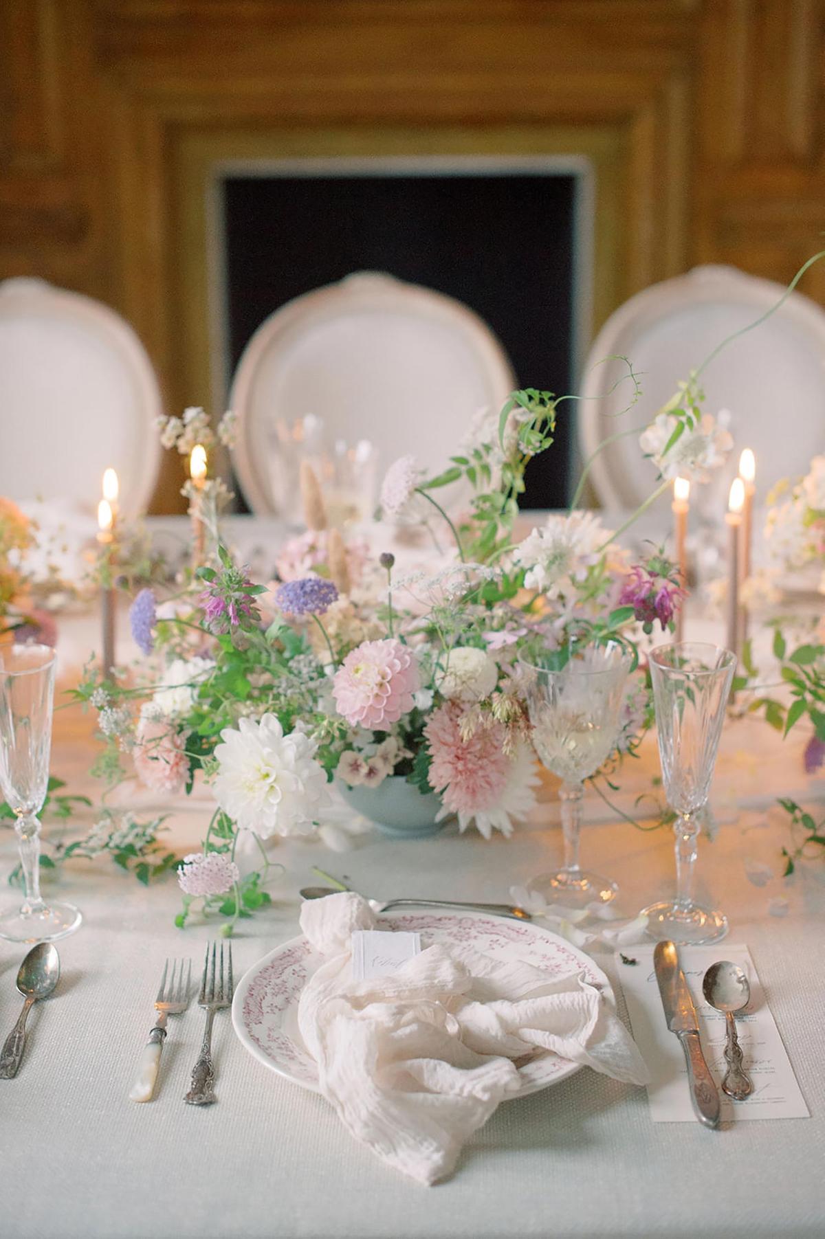spring ballroom wedding reception with a neutral table linen, soft silk runner and low garden centerpieces mixed with skinny taper candles; photography by Julie Livingston at an English country estate Hedsor House with planning and design by Willow and Oak Events
