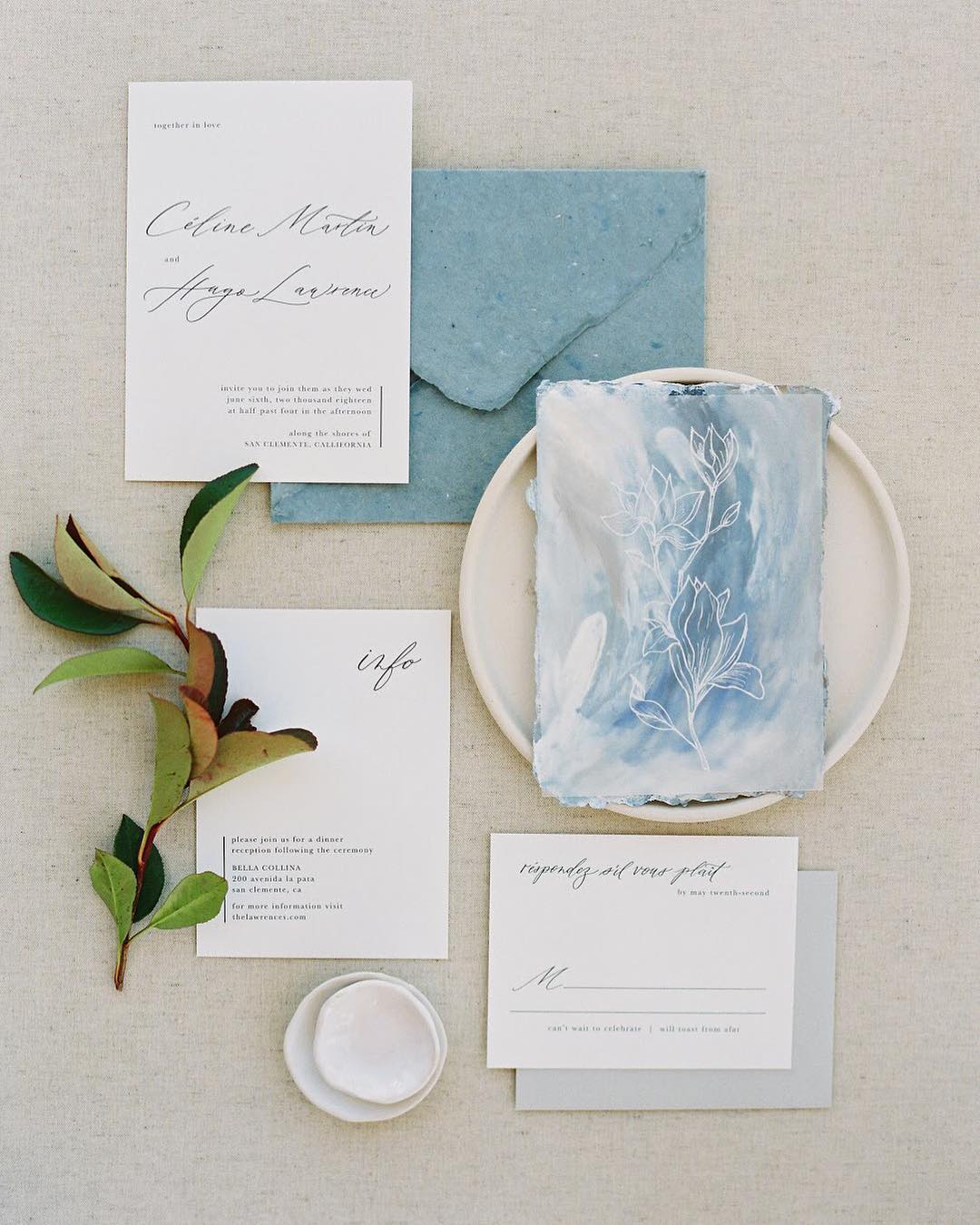 Elegant wedding invitations with deckle edge envelopes and a dusty blue art card by Dominique Alba | Photography and styling by Sara Weir