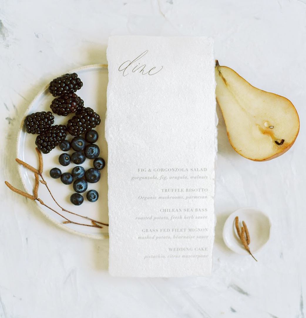 Deckle edge handmade paper wedding menu with soft fonts by Dominique Alba | Photography and styling by Gabriela Ines