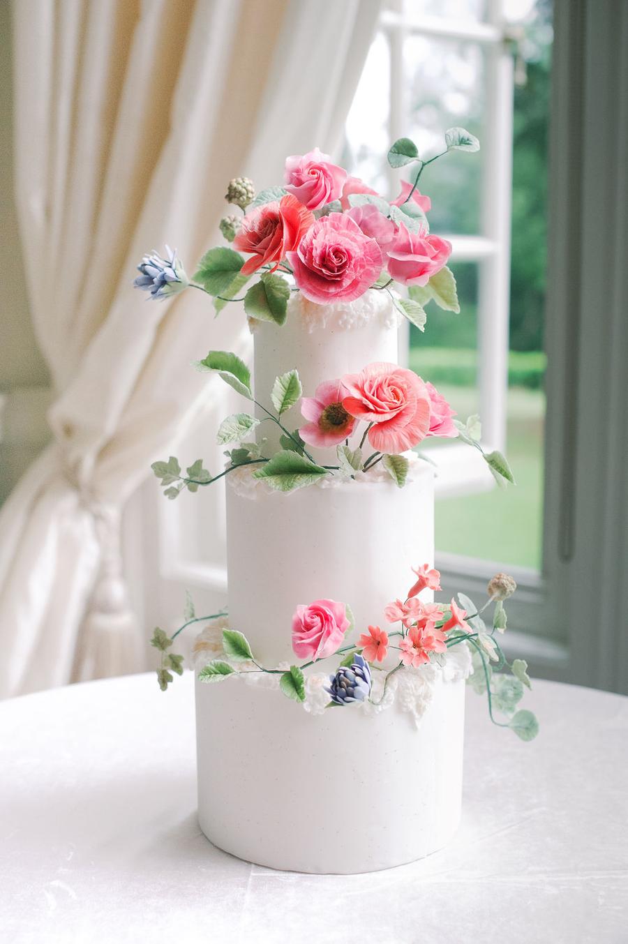English garden wedding with a sugar flower cake, luxury bridal gowns and pastel garden flowers || Photo by Julie Livingston with planning + design by Willow and Oak Events