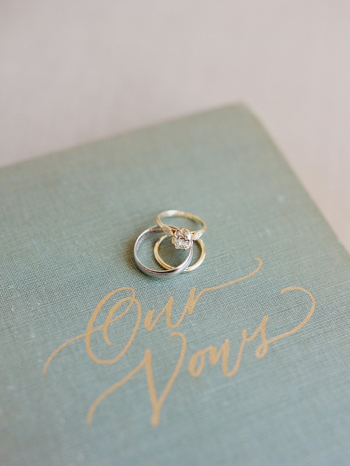 Vintage engagement ring with marquise cut accent diamond tapering the center round cut diamond; planning by Willow & Oak with photography by Kylee Yee