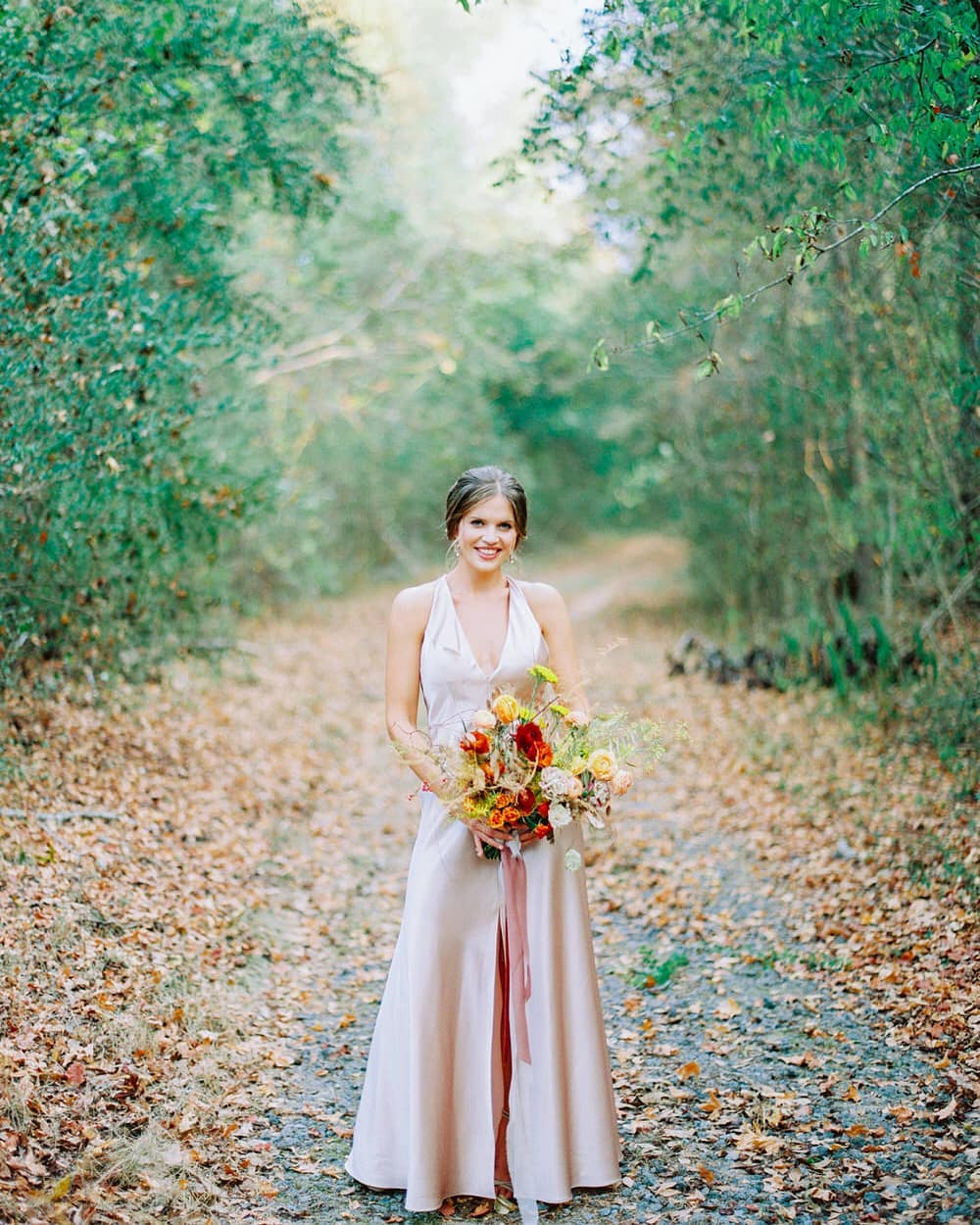 Silk apricot wedding dress with a wild fall bouquet and trailing ribbon; Photo by Brian D Smith Photography with planning + design by Willow and Oak Events