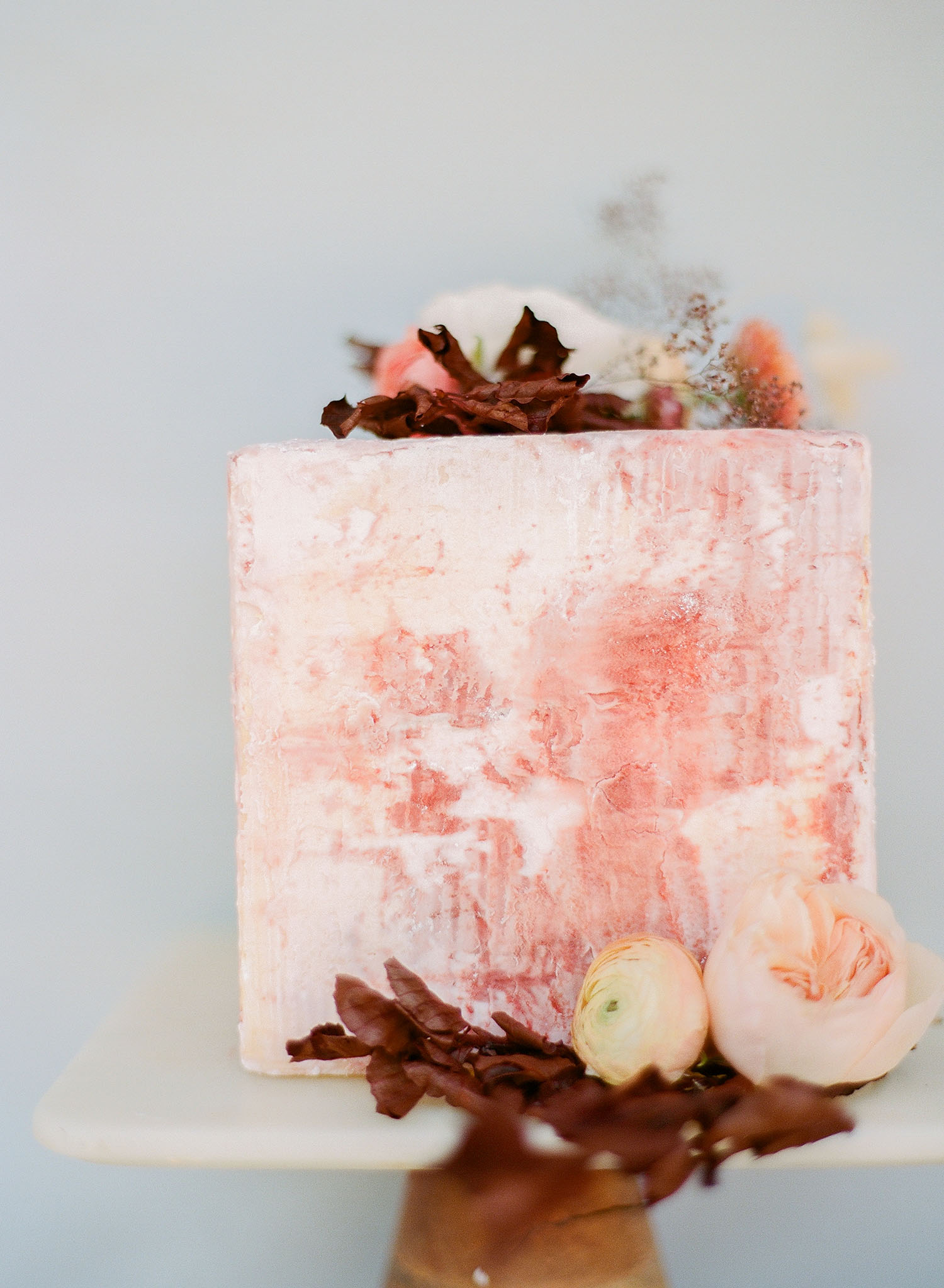 Rough stone wedding cake technique with terra cotta colors and fall foliage, designed by Annie's Cakes from a Charleston wedding planned by Willow and Oak Events