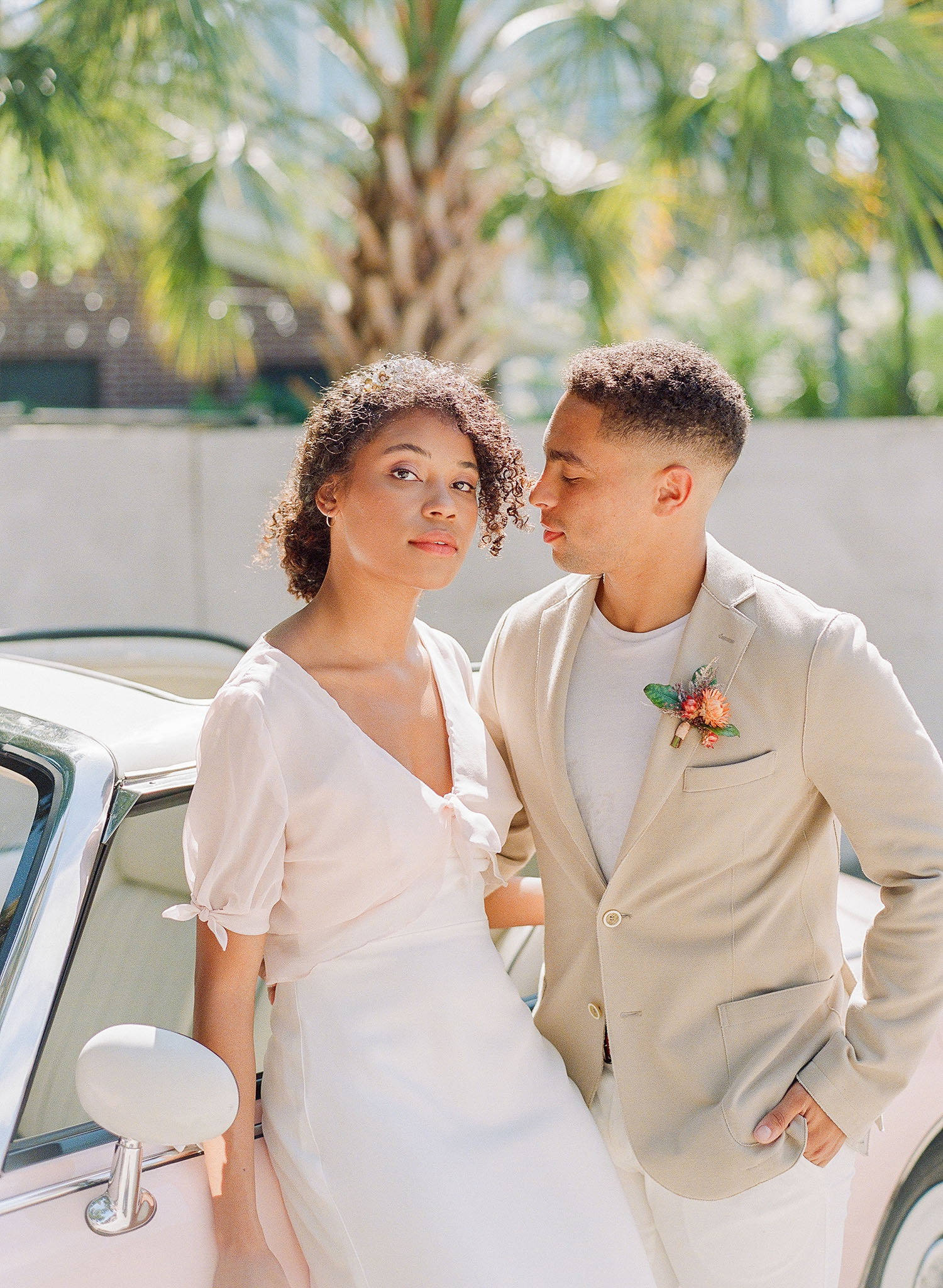 Emma Katzka crepe wedding dress with a delicate blush overlay and a tan suit jacket from M. Dumas & Sons, captured by Clay Austin and planned by Willow and Oak with fashion styling by The Edit Collective