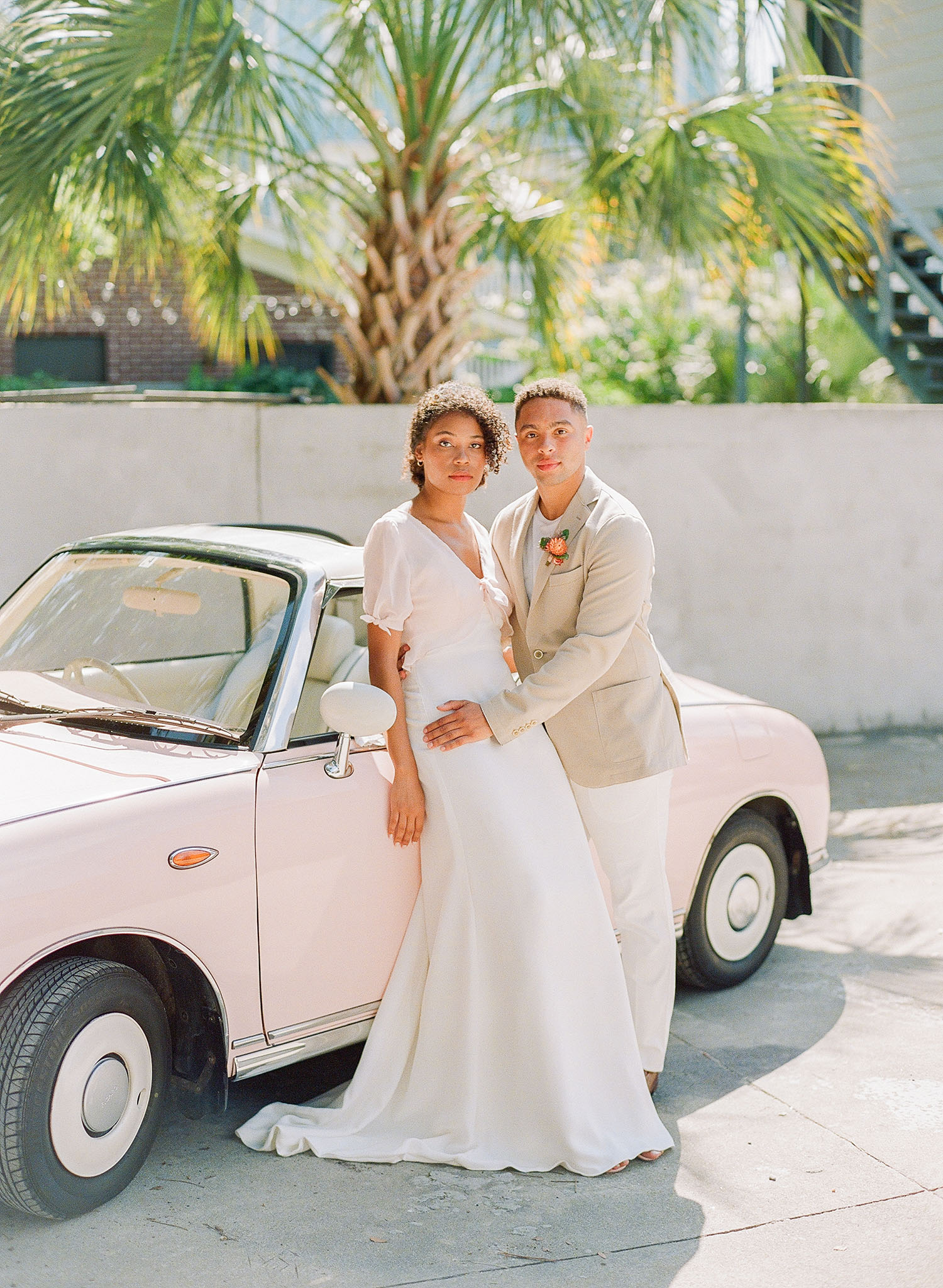 Emma Katzka crepe wedding dress with a delicate blush overlay and a tan suit jacket from M. Dumas & Sons, captured by Clay Austin and planned by Willow and Oak with fashion styling by The Edit Collective