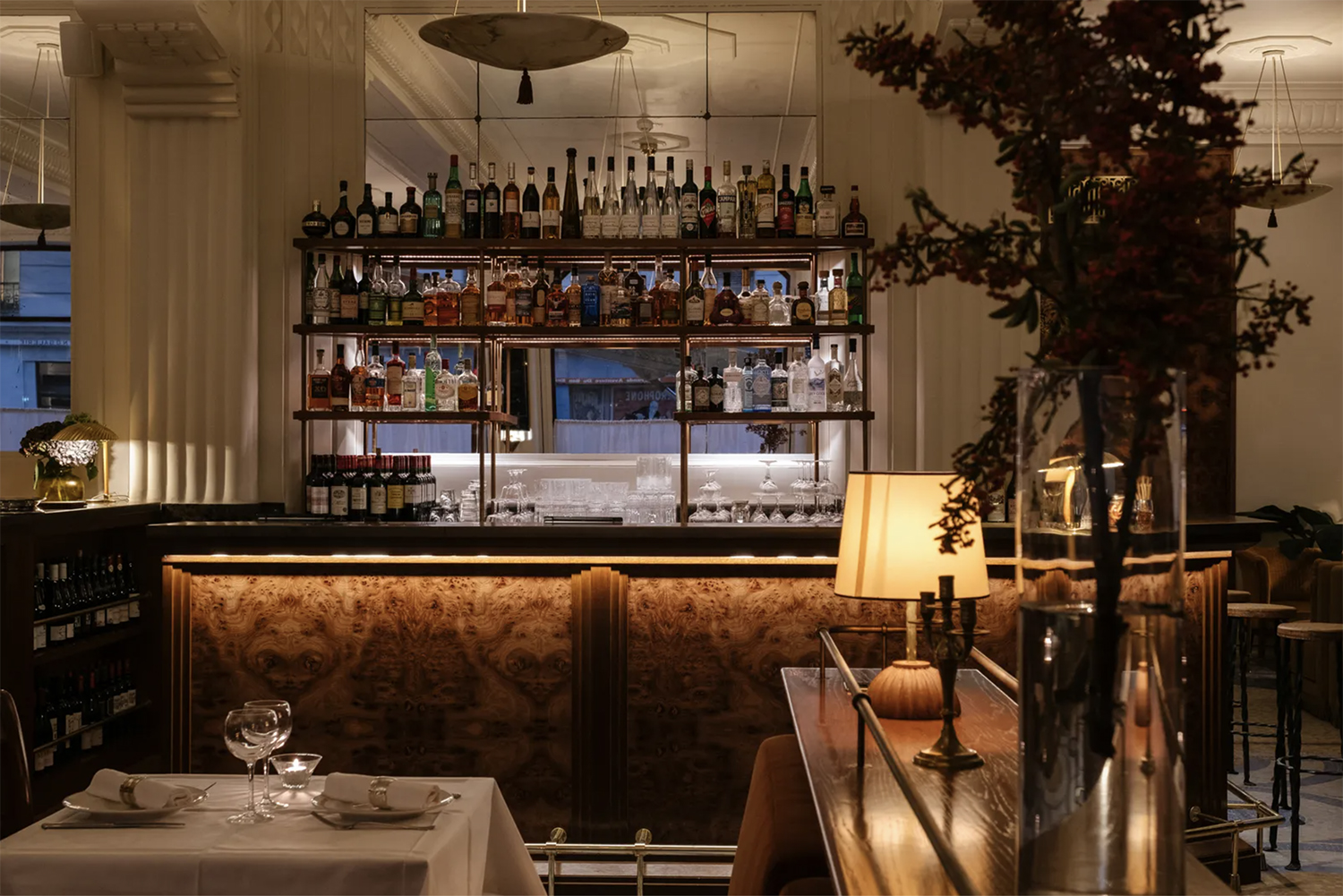 An uplit burl wood bar at Restaurant Rochechouart