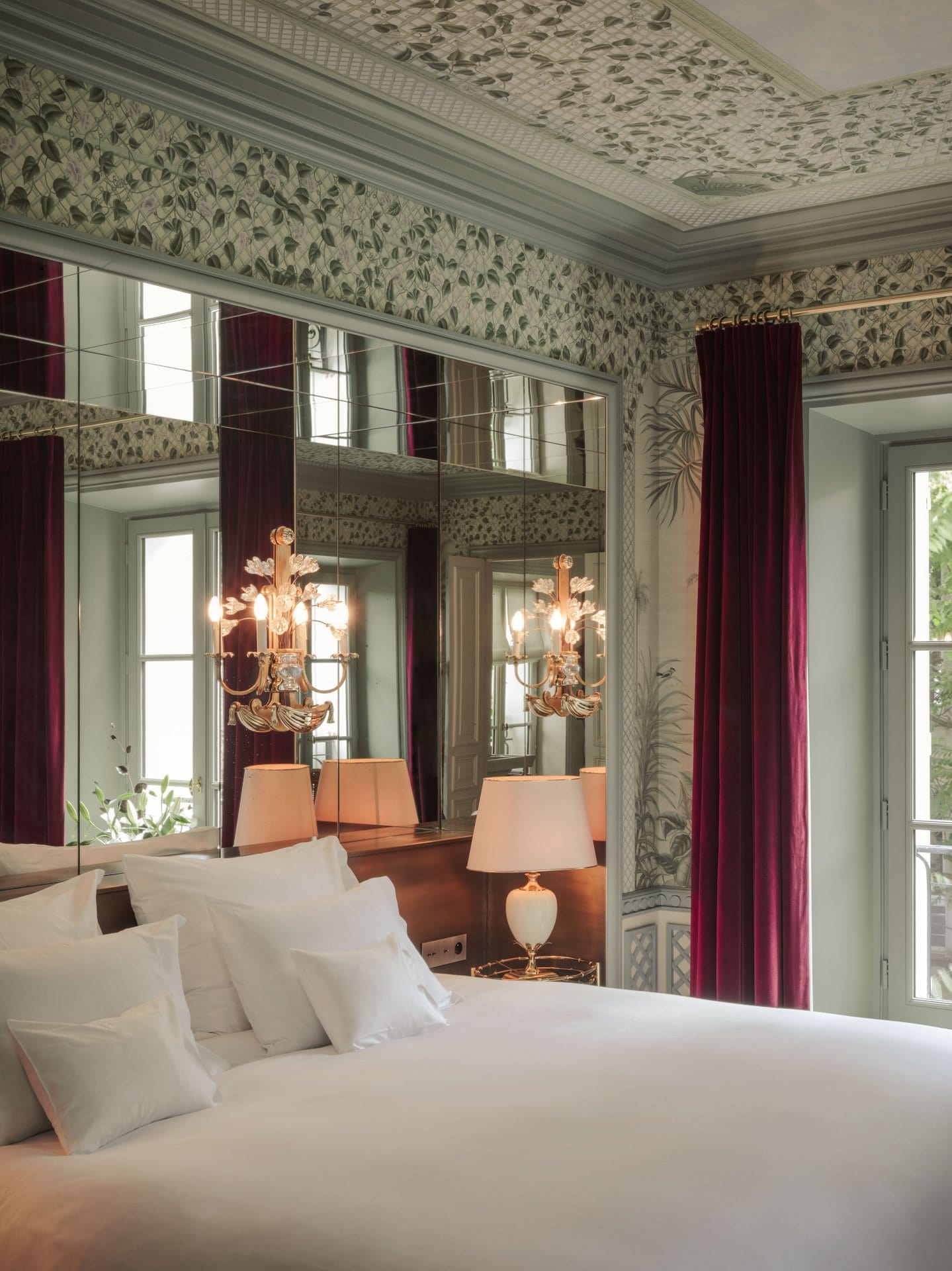 A tromp l'oueil garden latticework wallpaper design for one of the guestrooms at Hôtel Particulier Montmartre