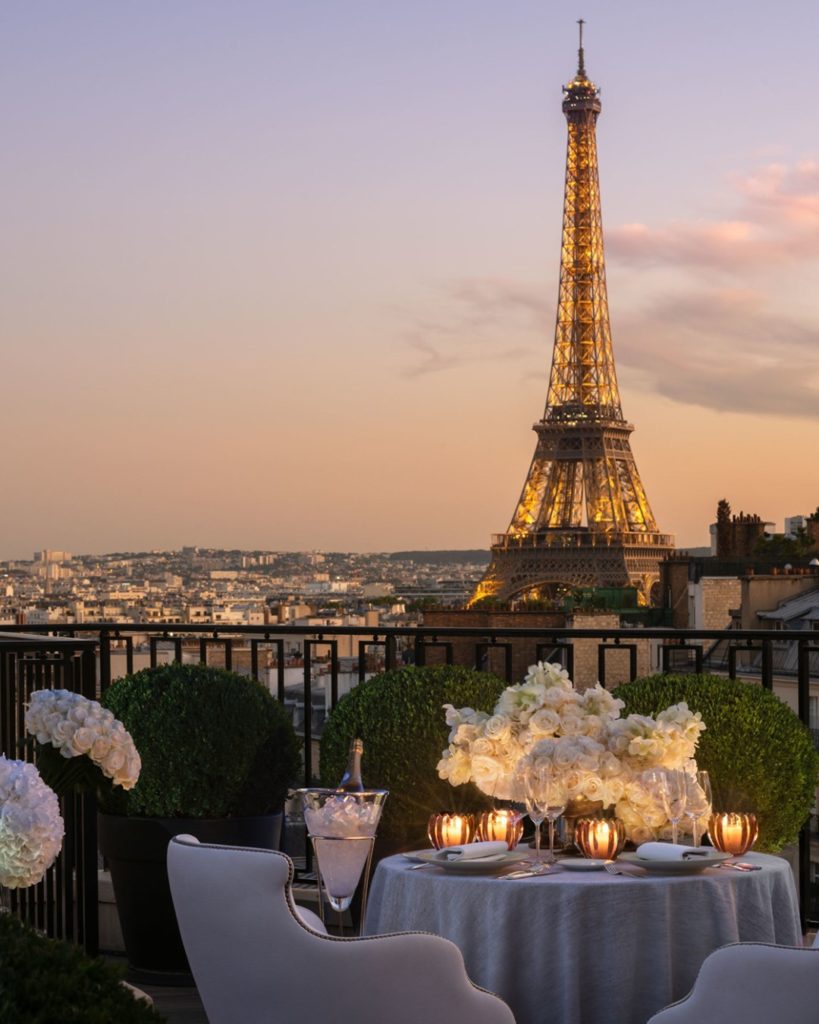 A romantic table for 2 on a rooftop balcony with Eiffel Tower views at the Four Seasons Paris