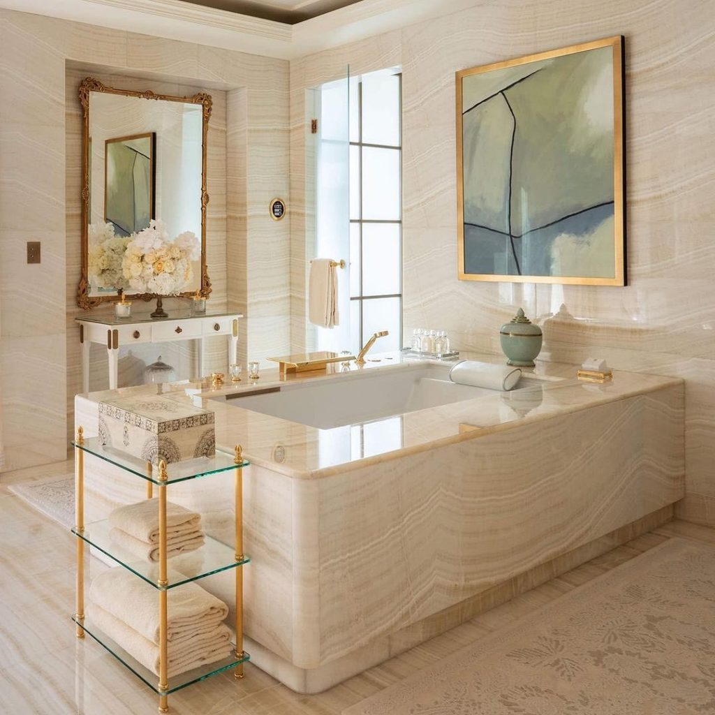 The glossy marbled bathtub of the Royal Suite at Four Seasons Hotel George V Paris
