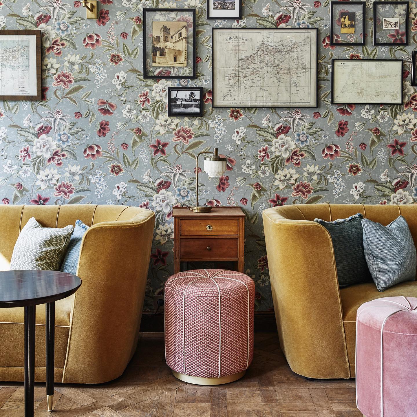 Jacque's Bar at The Hoxton Paris, with Marrakesh's Majorelle garden as the inspiration behind the design. Intricate floral wallpaper and plush lounge furniture fill the room, alongside upholstered poufs and accent cushions. 