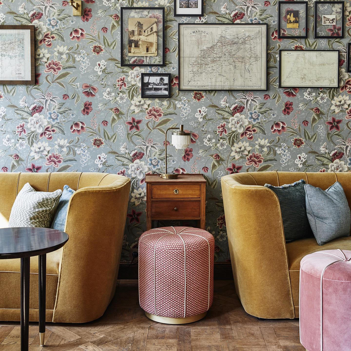 Jacque's Bar at The Hoxton Paris, with Marrakesh's Majorelle garden as the inspiration behind the design. Intricate floral wallpaper and plush lounge furniture fill the room, alongside upholstered poufs and accent cushions.