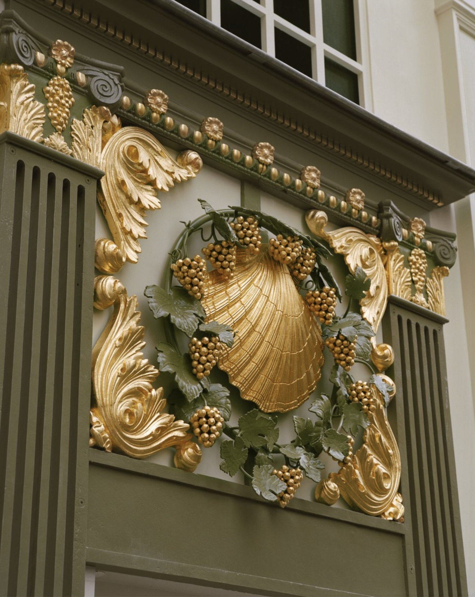 The original gold Rococo shell carving at the entrance to La Coquille d'Or at Chateau Voltaire