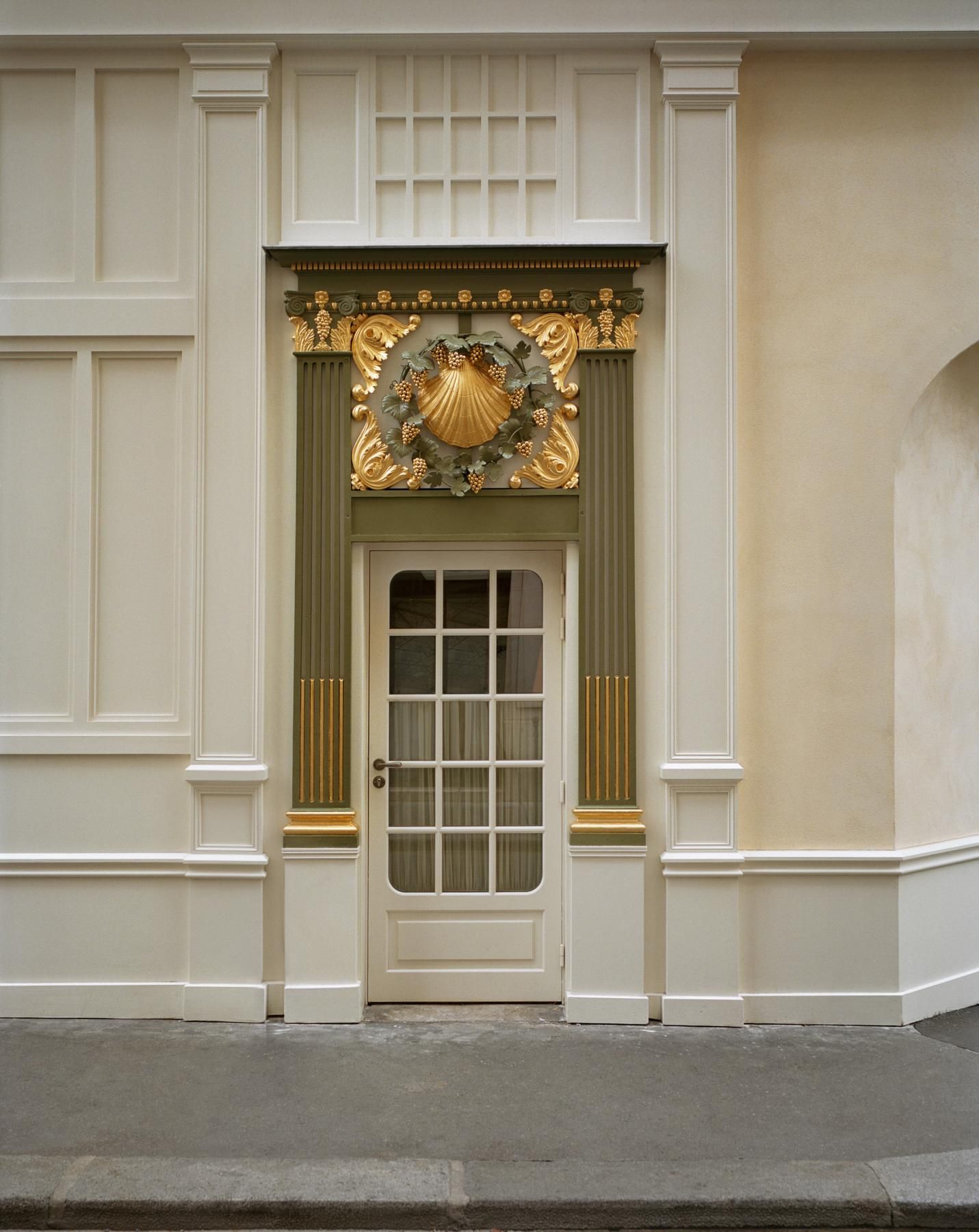 The original gold Rococo shell carving at the entrance to La Coquille d'Or at Chateau Voltaire