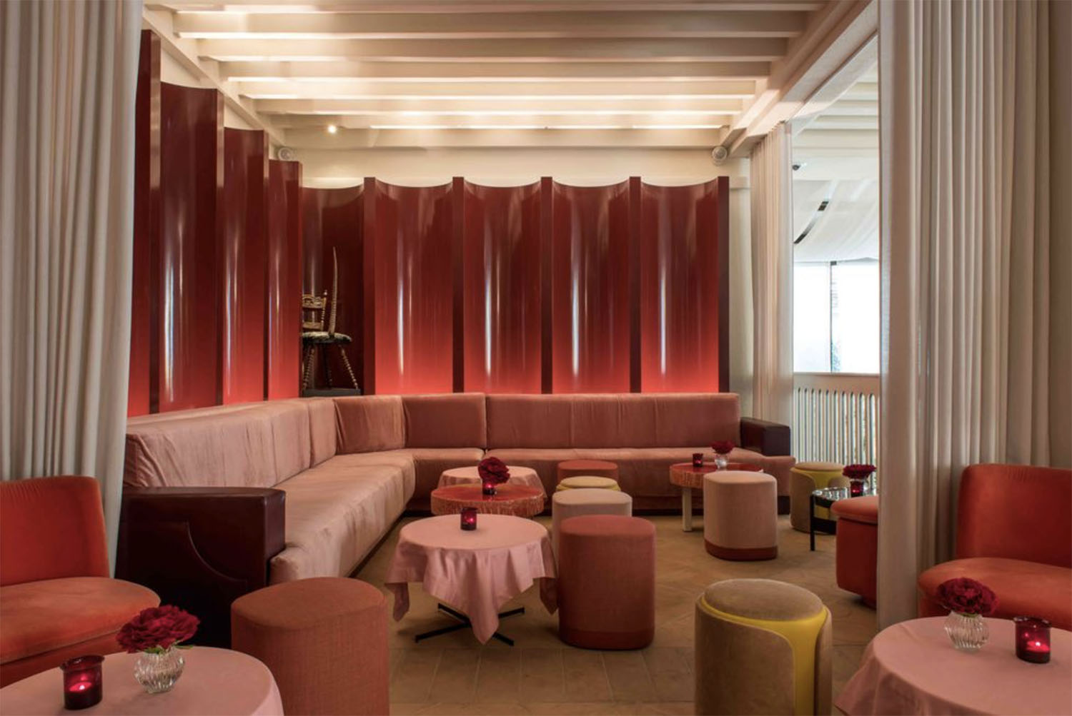 The plush velvet bistro tables, sofas and poufs in the Hotel Sinner Lounge