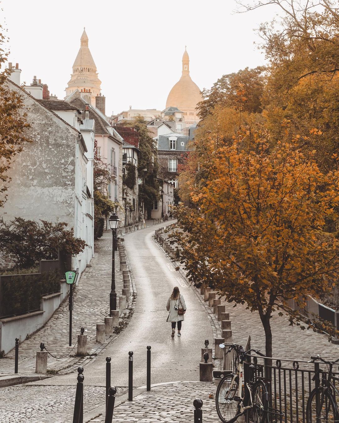 A woman walks up the long and winding road in Montmartre
