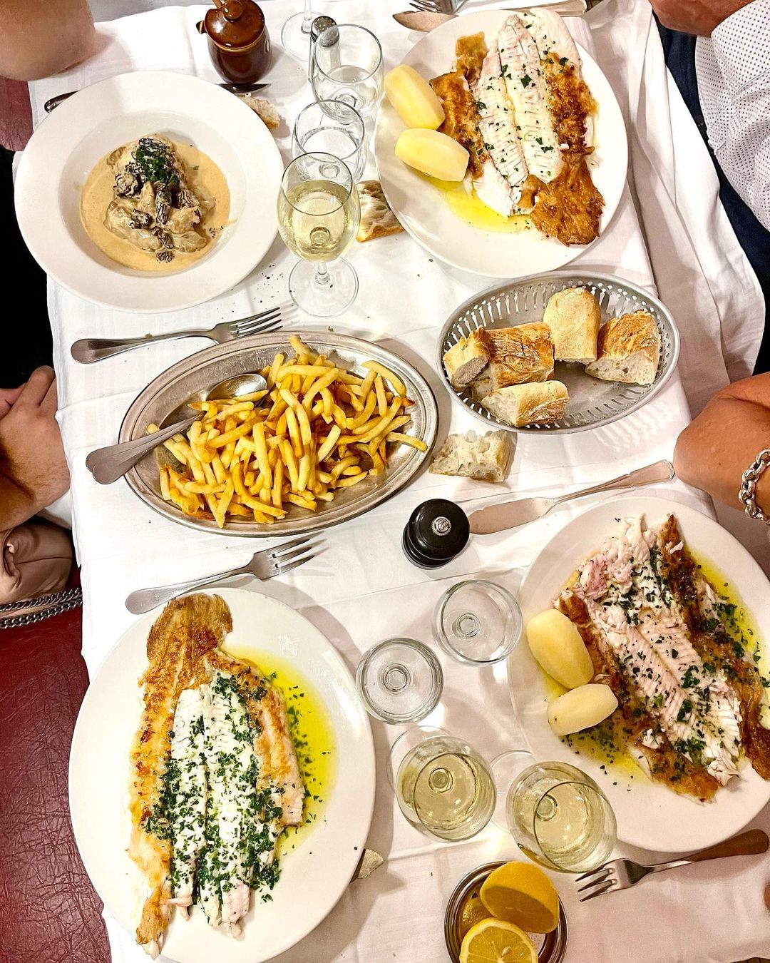 A bird's eye view of Pommes Frites and whole fish dishes at Chez Georges