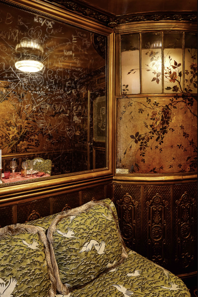 The gold and sage Asian chinoiserie motifs in the historic salon at Lapérouse