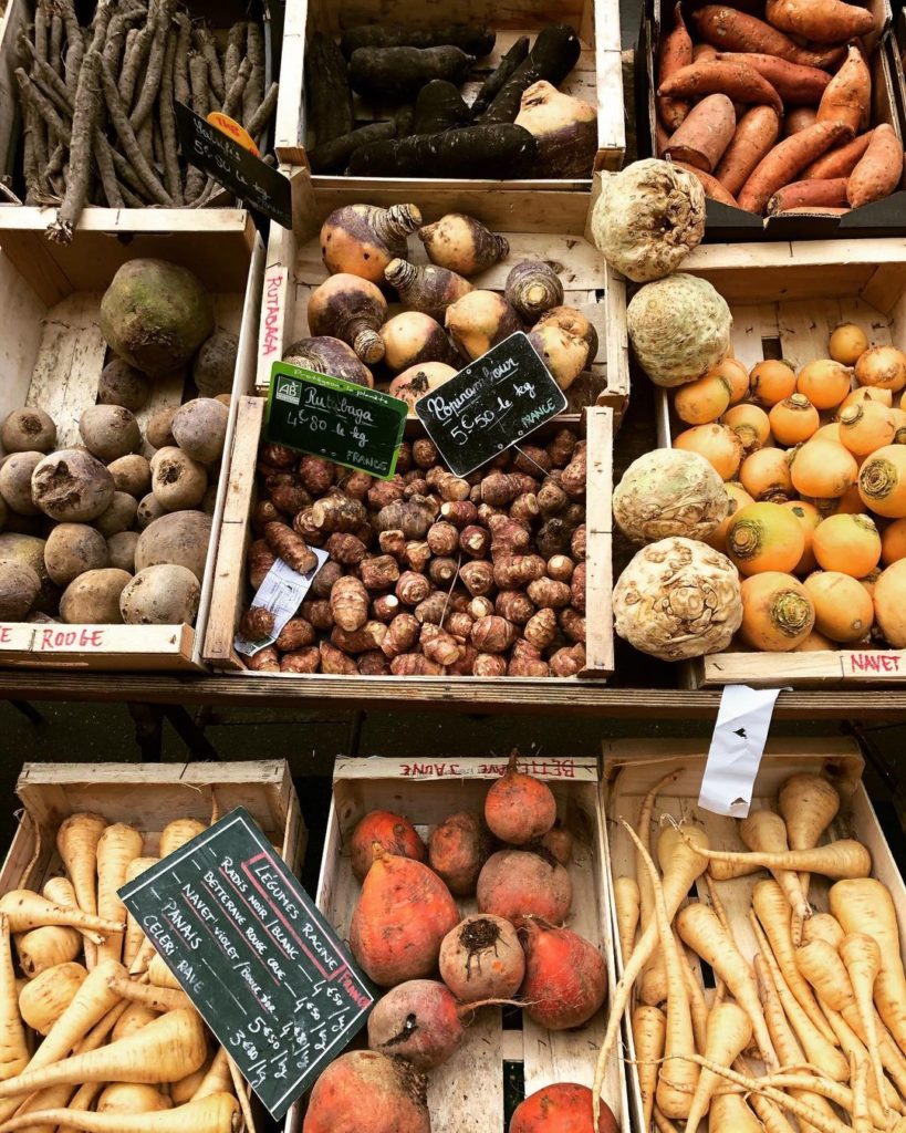 Wooden crates filled with fresh produce at Marché Raspail