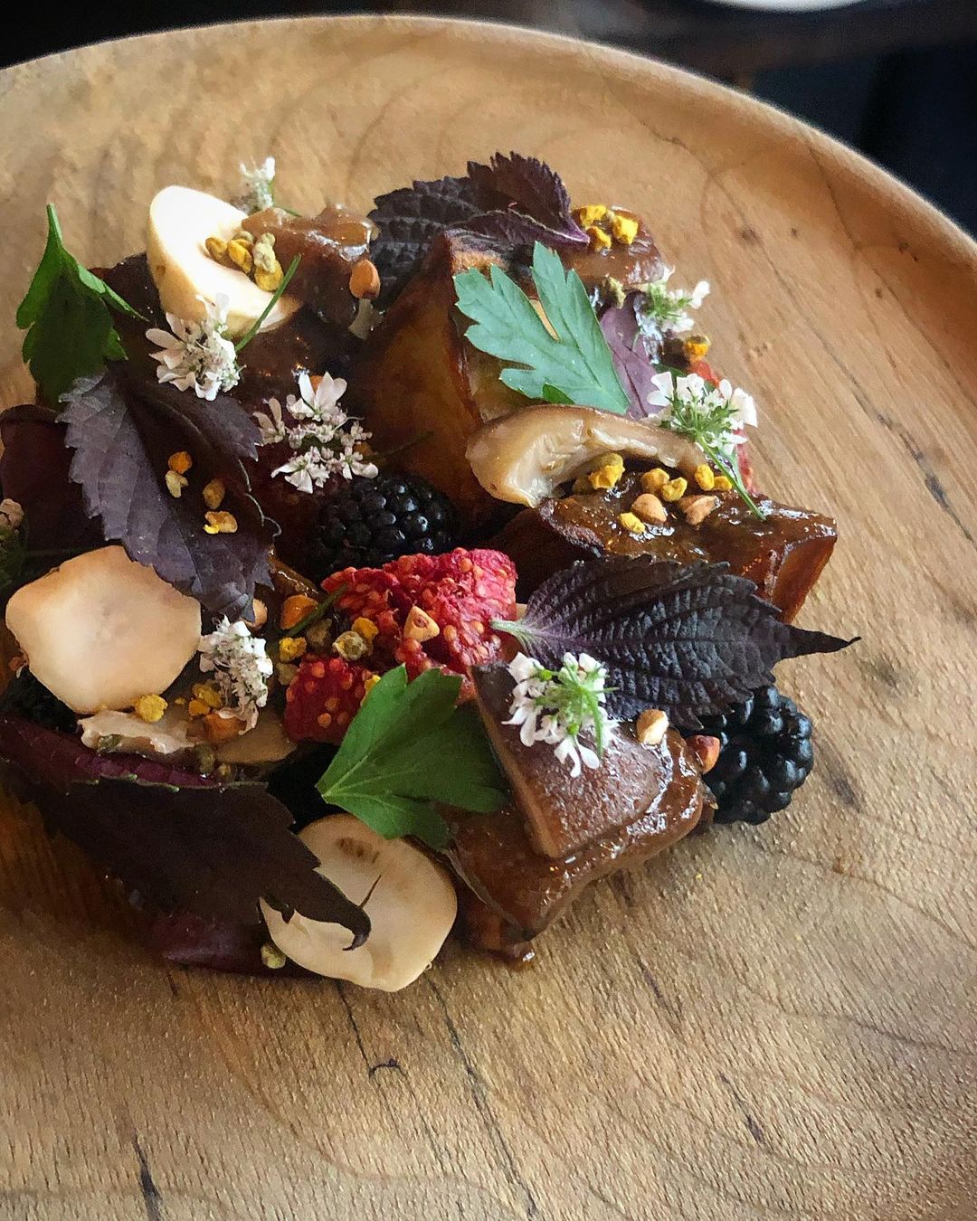 A deep fried eggplant dish with fig, hazelnut, blackberries, pollen, parsley and more at Septime