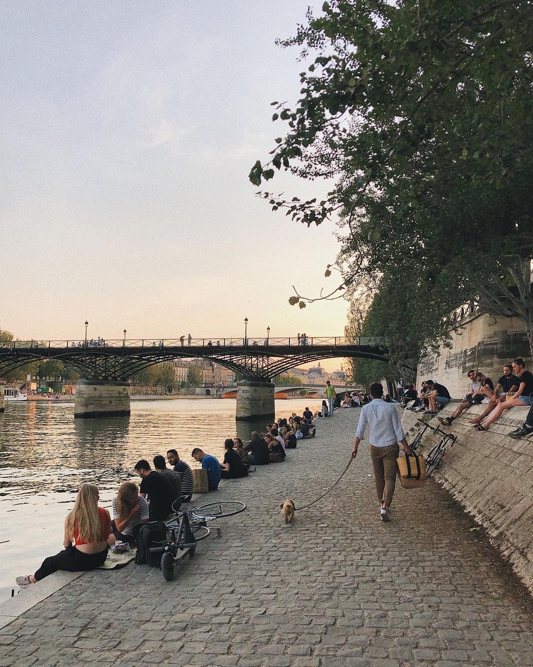 Groups of couples and friends gather for a break along the Seine