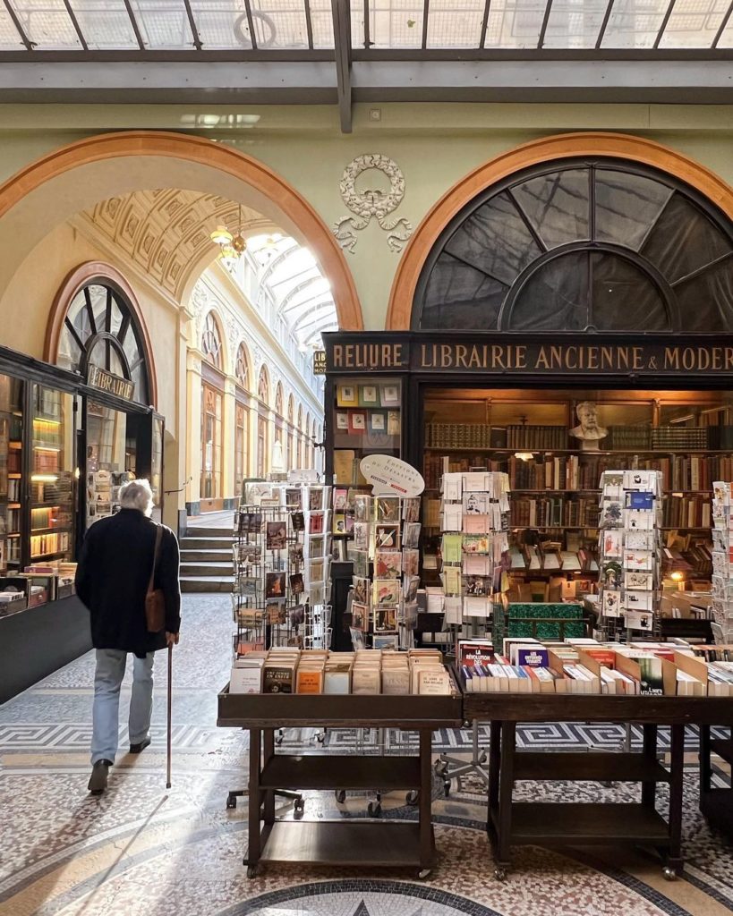 A man walks by the wood-paneled bookstore inside Galerie Vivienne
