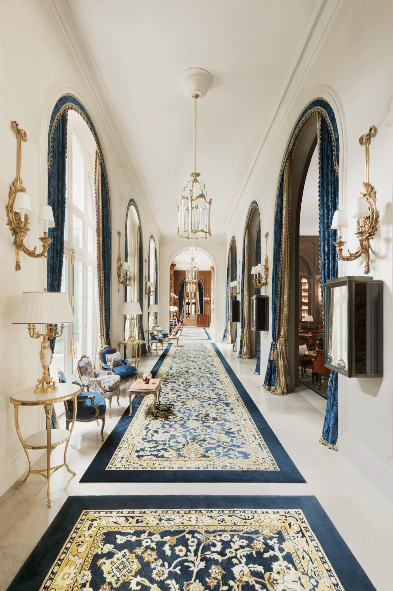 The navy, gold and white corridor at Ritz Paris that extends from the Lobby and past the Tea Salon